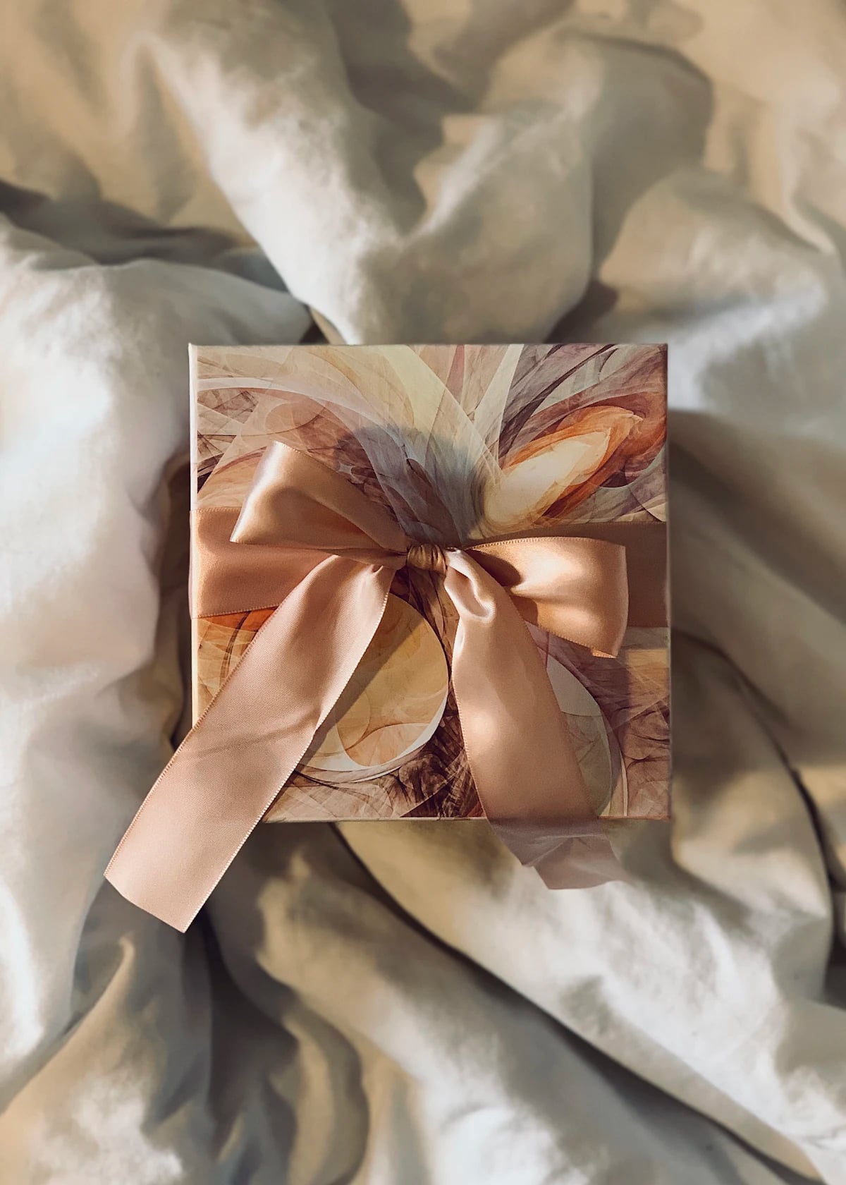 Champagne gift box on linen with a blush satin ribbon tied by hand